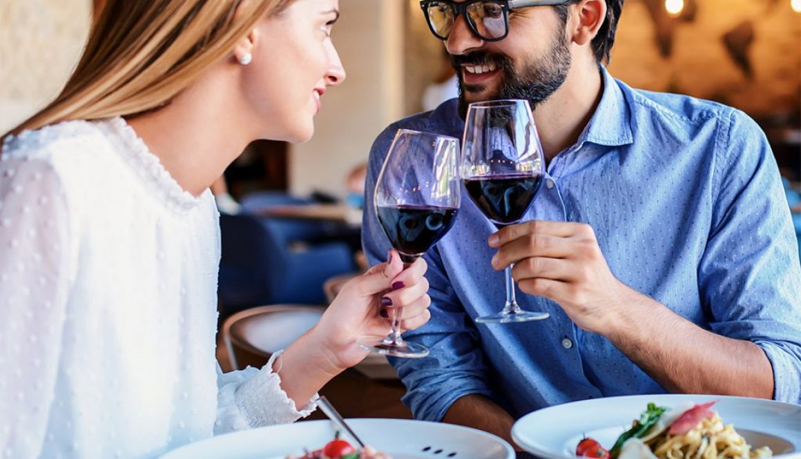 Paste and red wine. Young couple enjoying lunch in the restauran