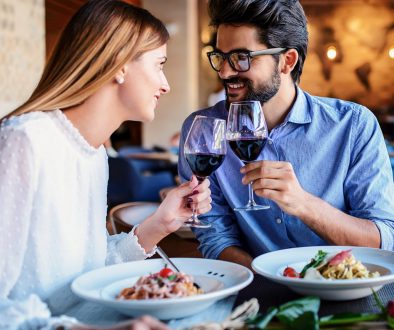 Paste and red wine. Young couple enjoying lunch in the restauran
